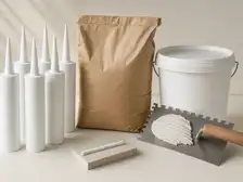 Unbranded mortar bags, sealant cartridges, compounds and preparation tools in a material display.