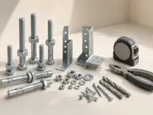Fasteners, anchors, hand tools and drill bits arranged on a work surface.